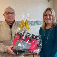 Prize winner holding gift basket.